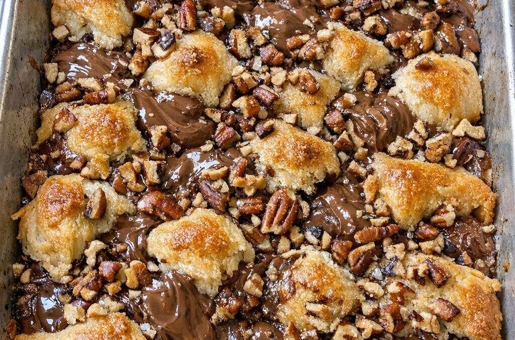 Toss unwrapped raw milk chocolate kisses in the sheet pan with 2 extra ingredients to bake a dessert so mouthwatering…